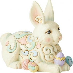 Laying down, this sweet bunny is as relaxed as he is happy. Surrounded by painted Easter eggs, this little rabbit is ready for showers and flowers.